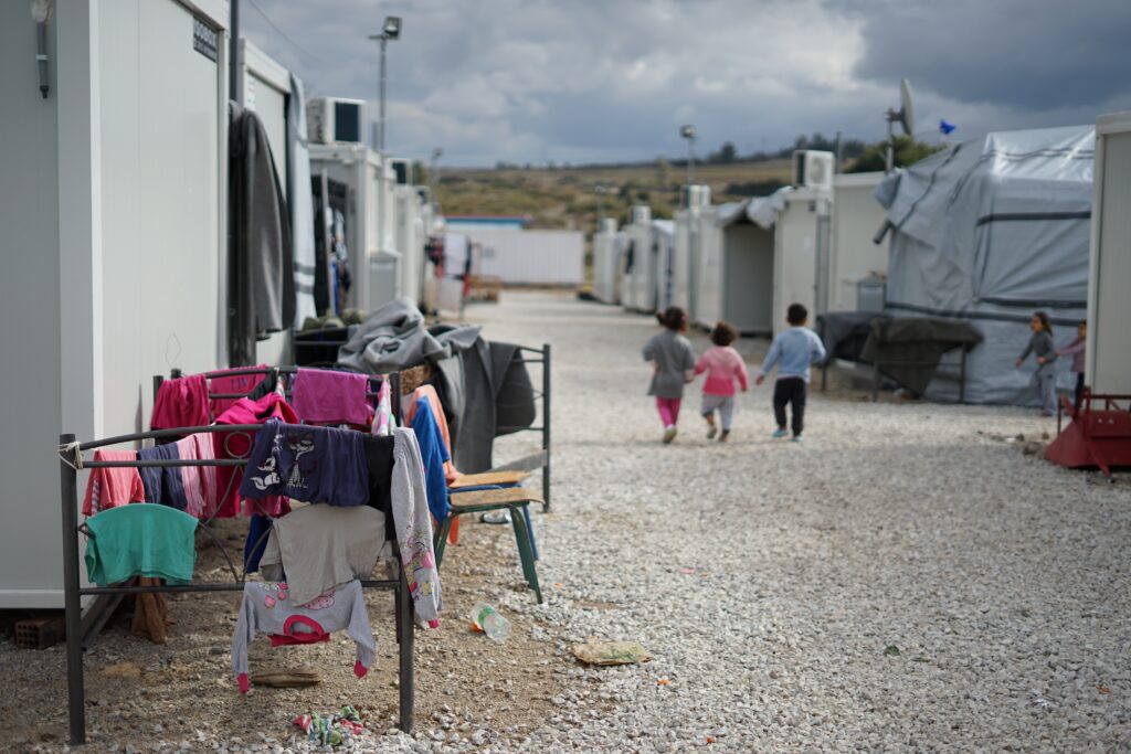 Photo of children walking through village.
